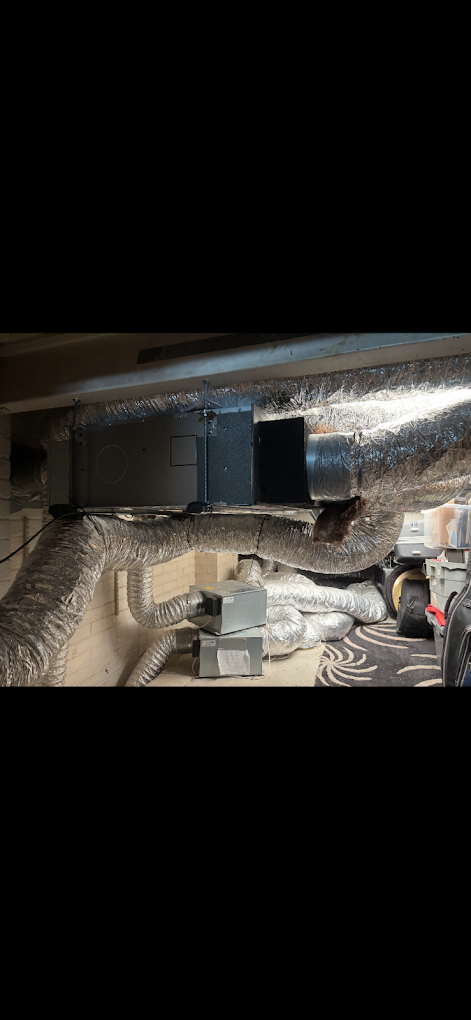 Suspended HVAC unit with insulated ductwork in a basement utility room